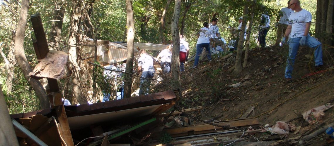 debris in beech bend with people in river bank